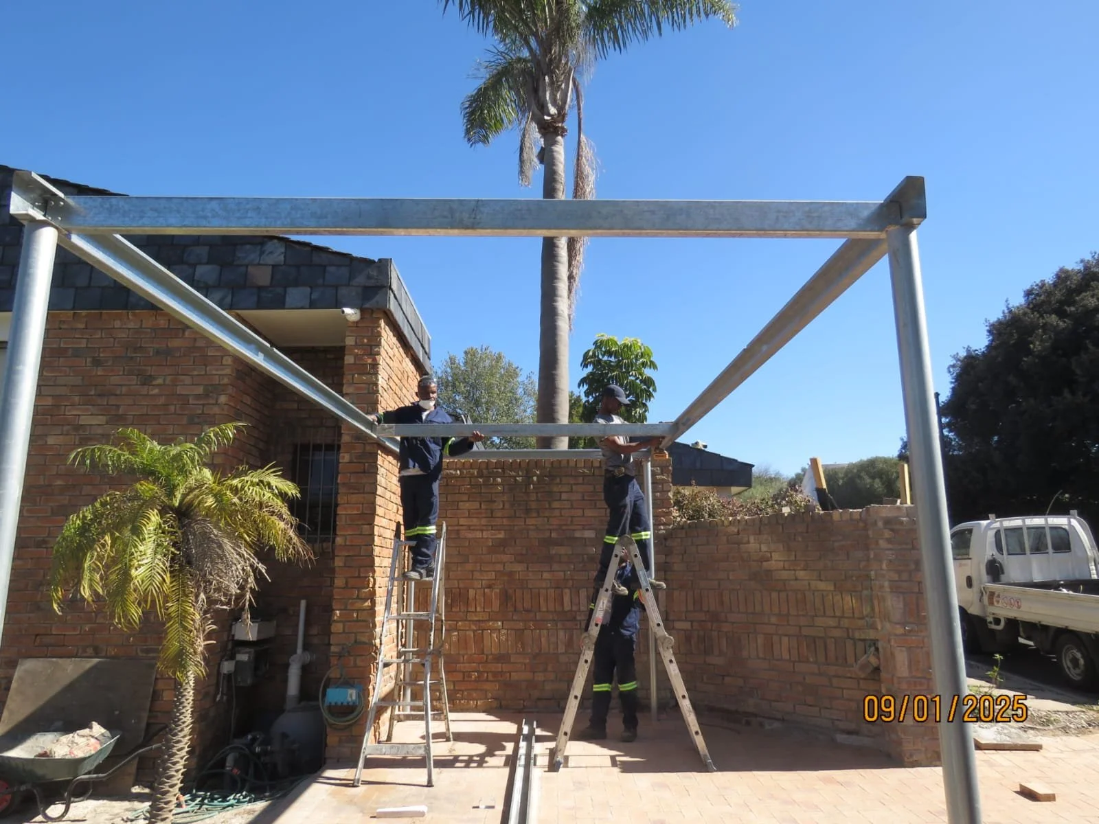 Steel frame structure beside a brick building